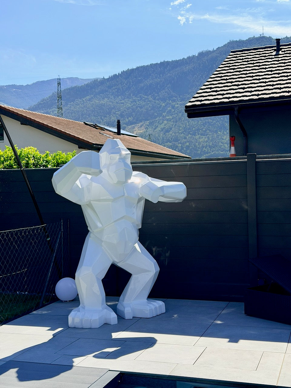 Kongari Collection — sculpture gorille origami Blanc Alpin H200 cm en résine laquée anti-UV, installée sur une terrasse face aux Alpes suisses
